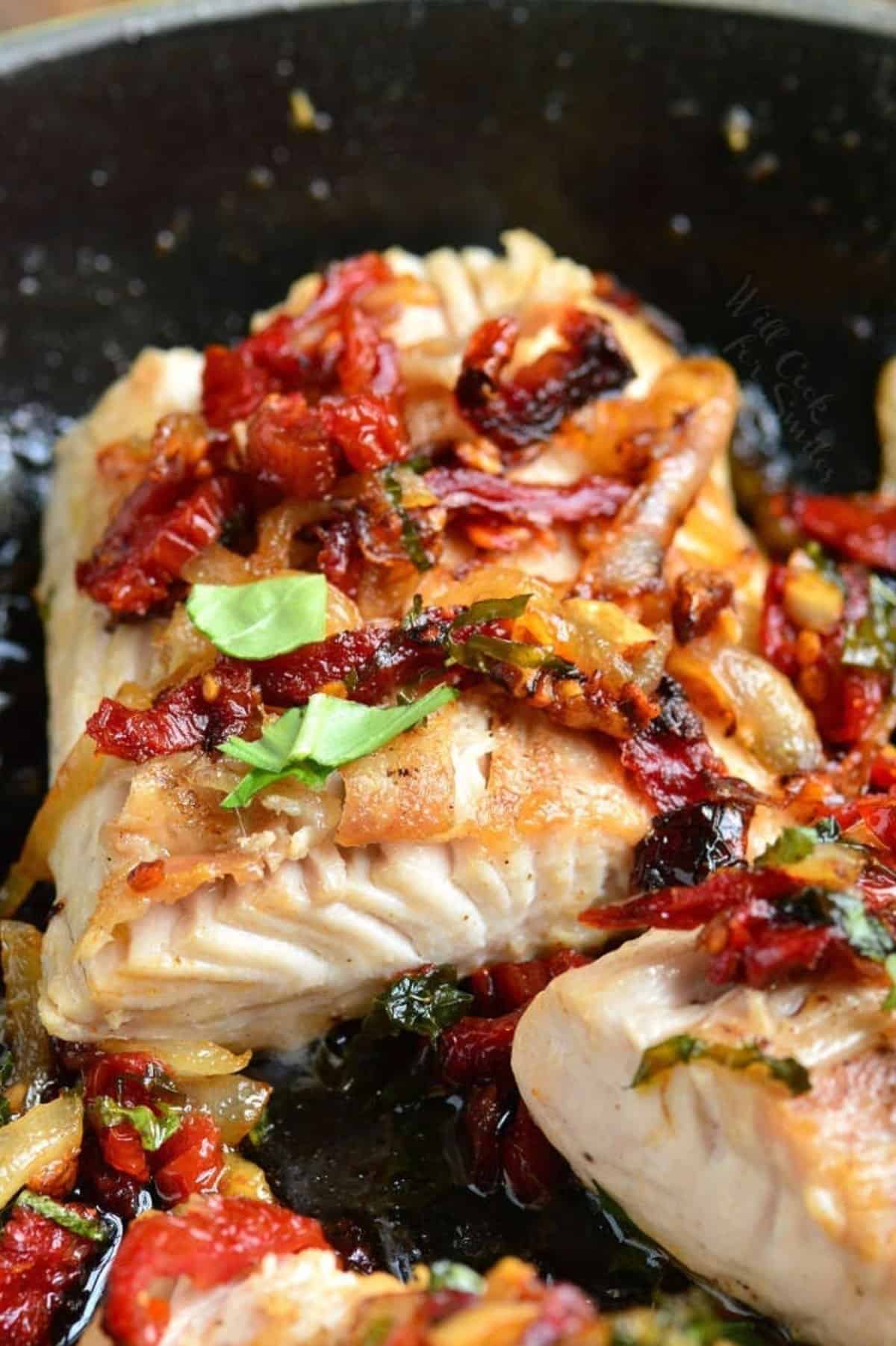 a thick juicy mahi mahi filet baked with sun dried tomato and basil topping.