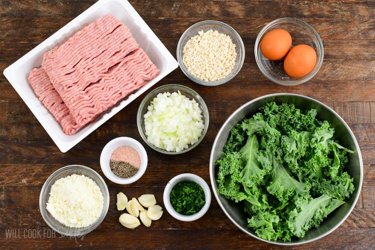 ingredients to make the kale and feta turkey burgers laid out on the wooden board.