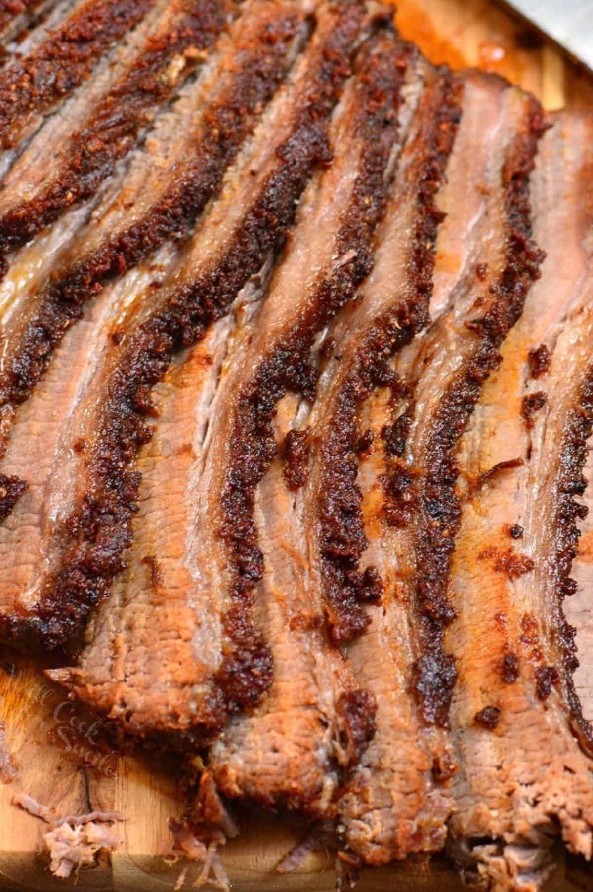 closeup sliced juicy and tender beef brisket cooked in the oven with dry rub.