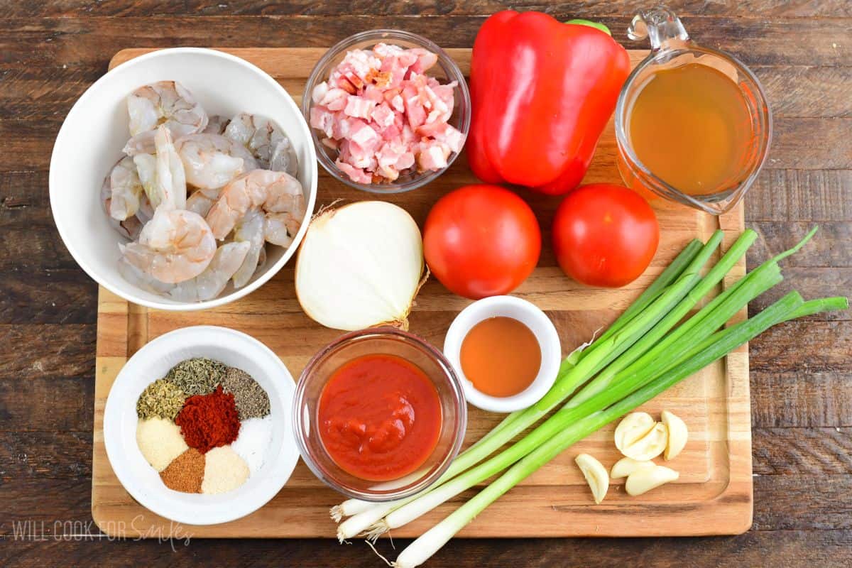 Ingredients for Cajun shrimp and rice on a cutting board.