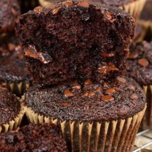 Chocolate zucchini muffins one cut in half on top of a whole muffin.