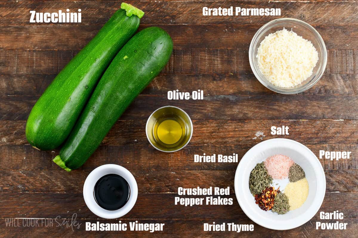 labeled Ingredients for roasted zucchini a on a wooden surface