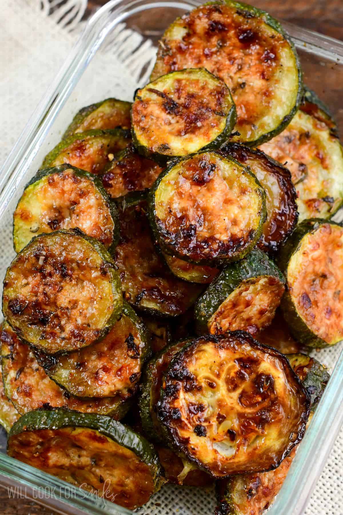 roasted zucchini stacked up in a dish.