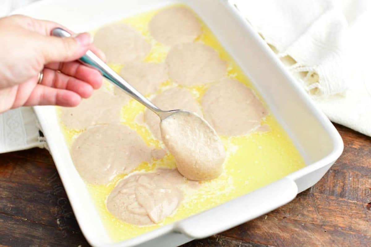 dropping spoonfuls of batter into butter in the baking dish.