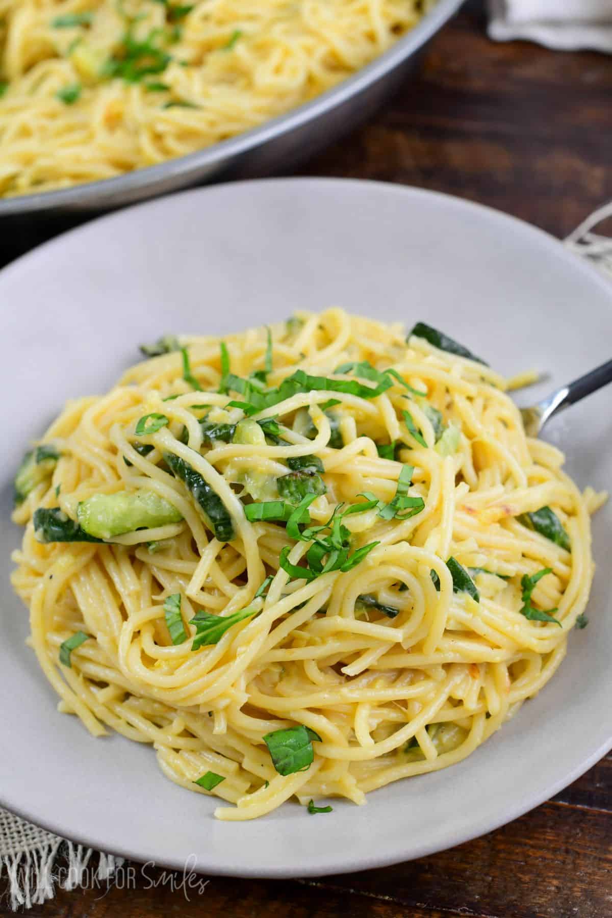Zucchini pasta in a bowl with a fork to the side.