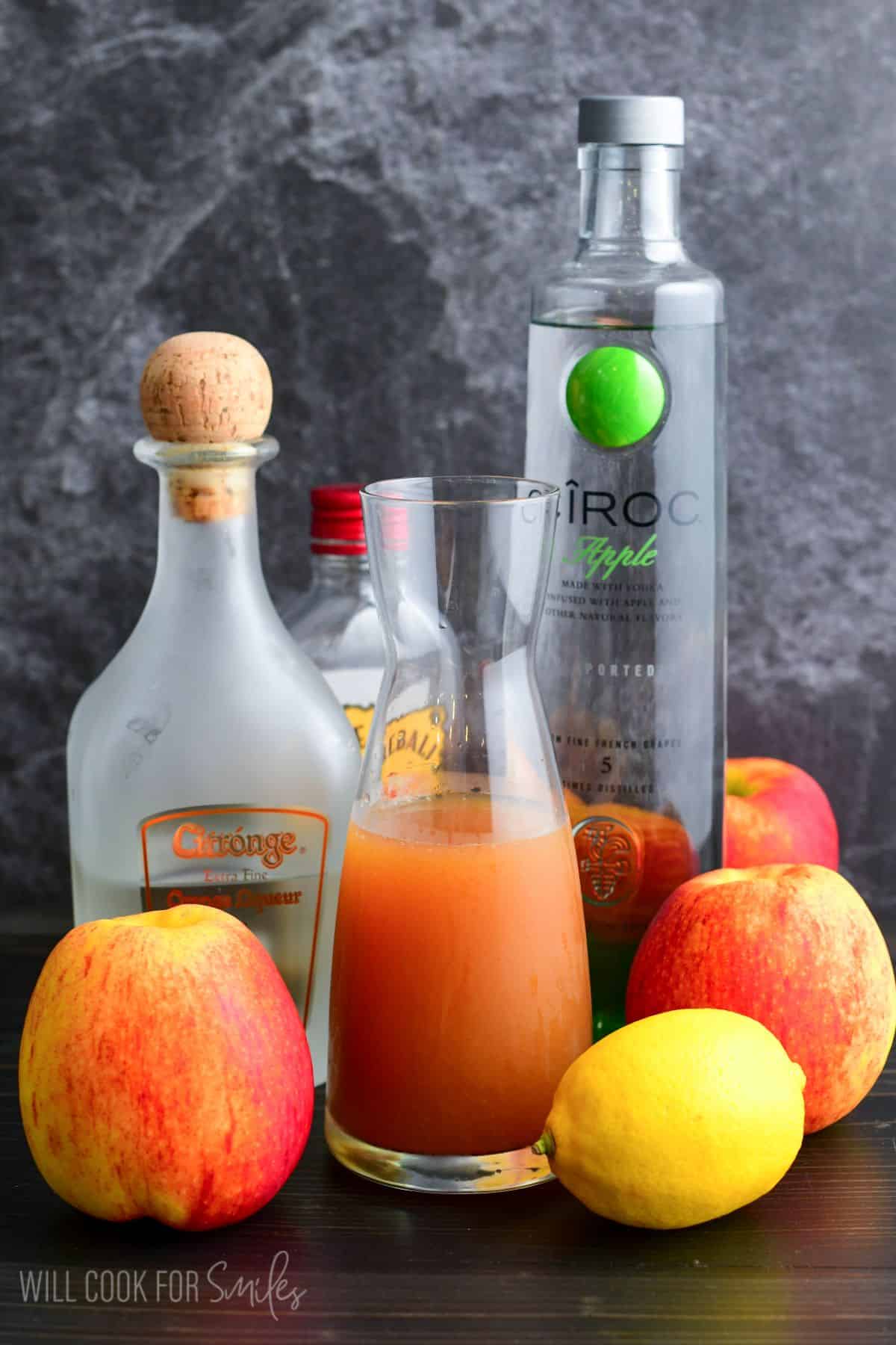 Ingredients for pumpkin cider martini on a wood surface.