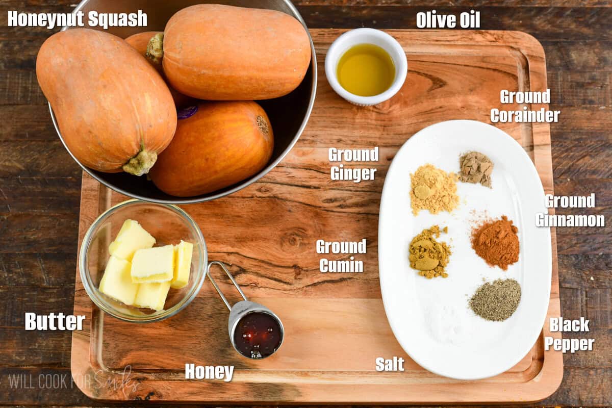 Labeled ingredients for Spiced Roasted Honeynut Squash on a wood surface.