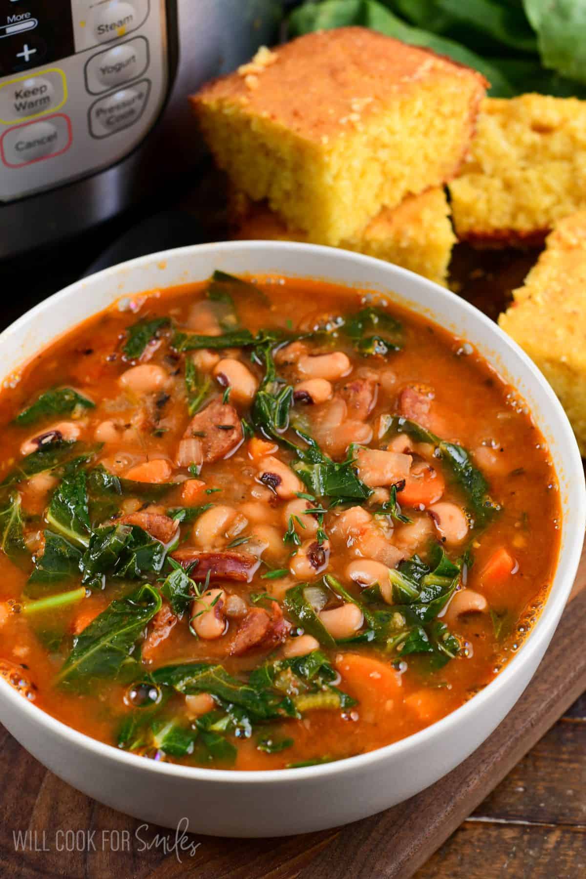 warm and hearty Southern black eyed pea soup made with tomato based broth, andouille sausage, and collard greens.