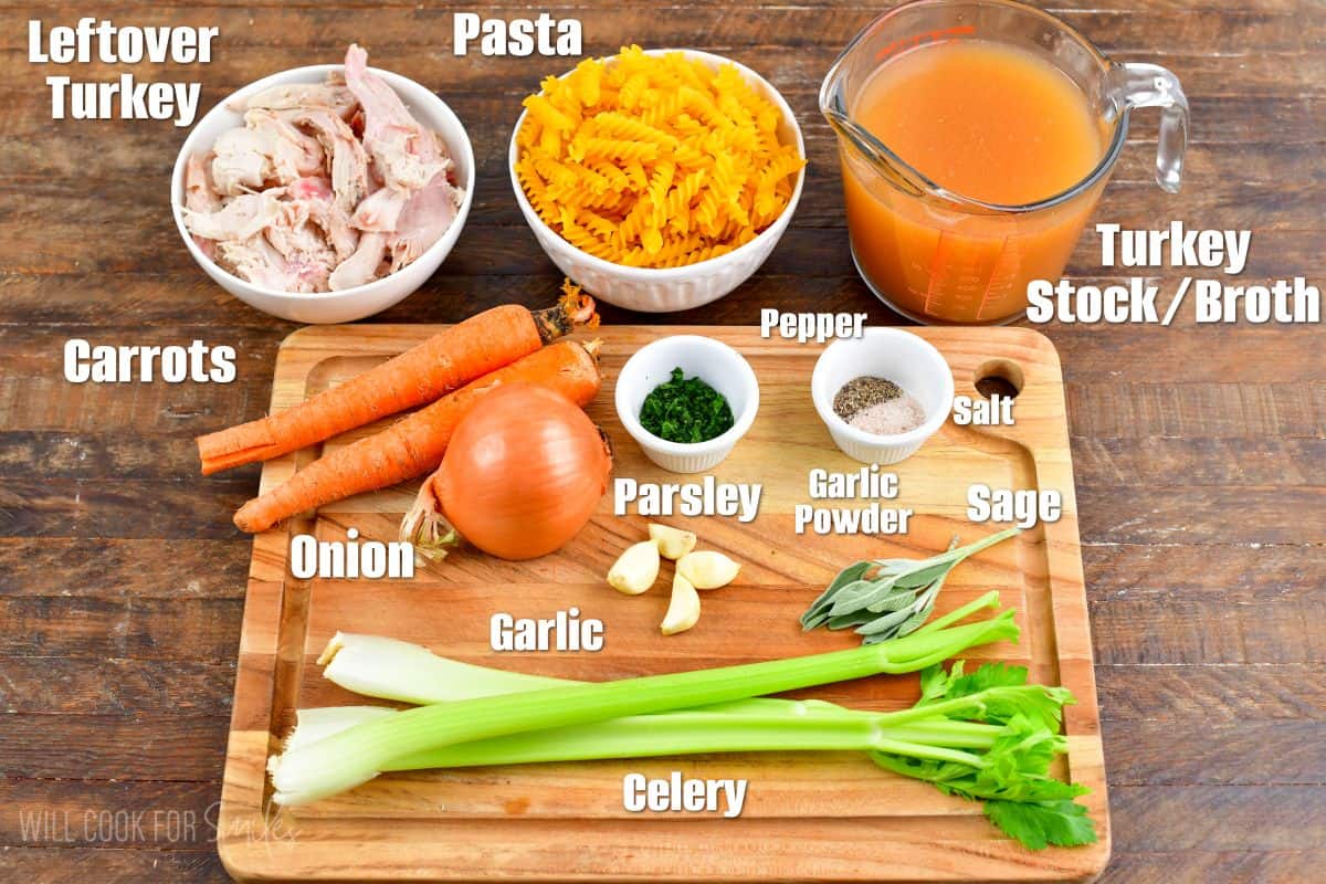 labeled ingredients to make leftover turkey noodle soup on and next to a cutting board.