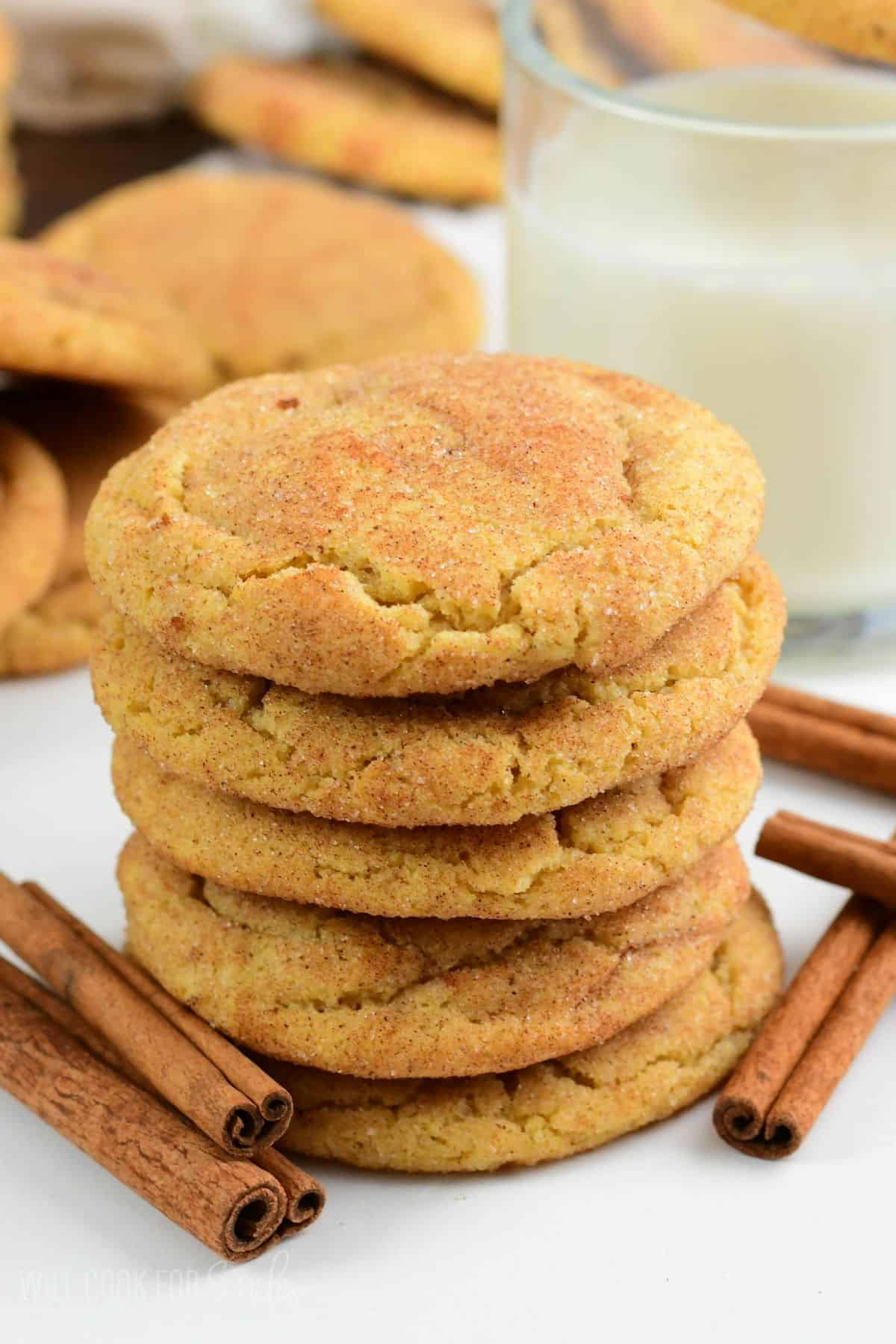 soft and chewy snickerdoodle cookies made with brown butter stacked next to glass of milk.
