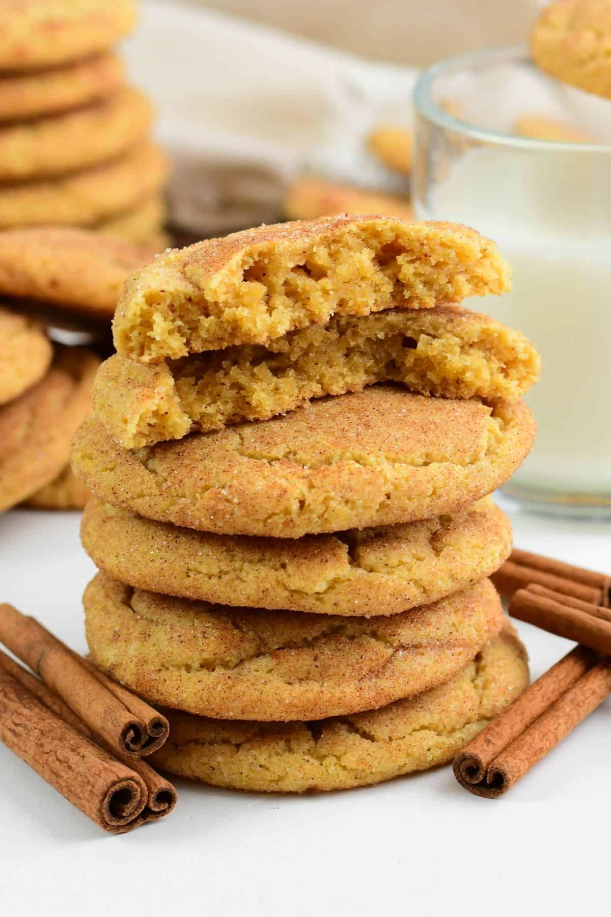 stacked brown butter snickerdoodles with one broken in half to see inside.