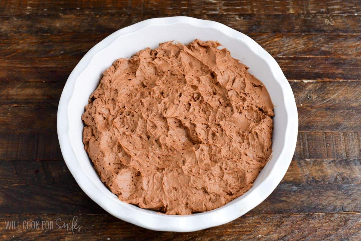 sooth and fluffy chocolate cheesecake mixture in the baking dish spread evenly.