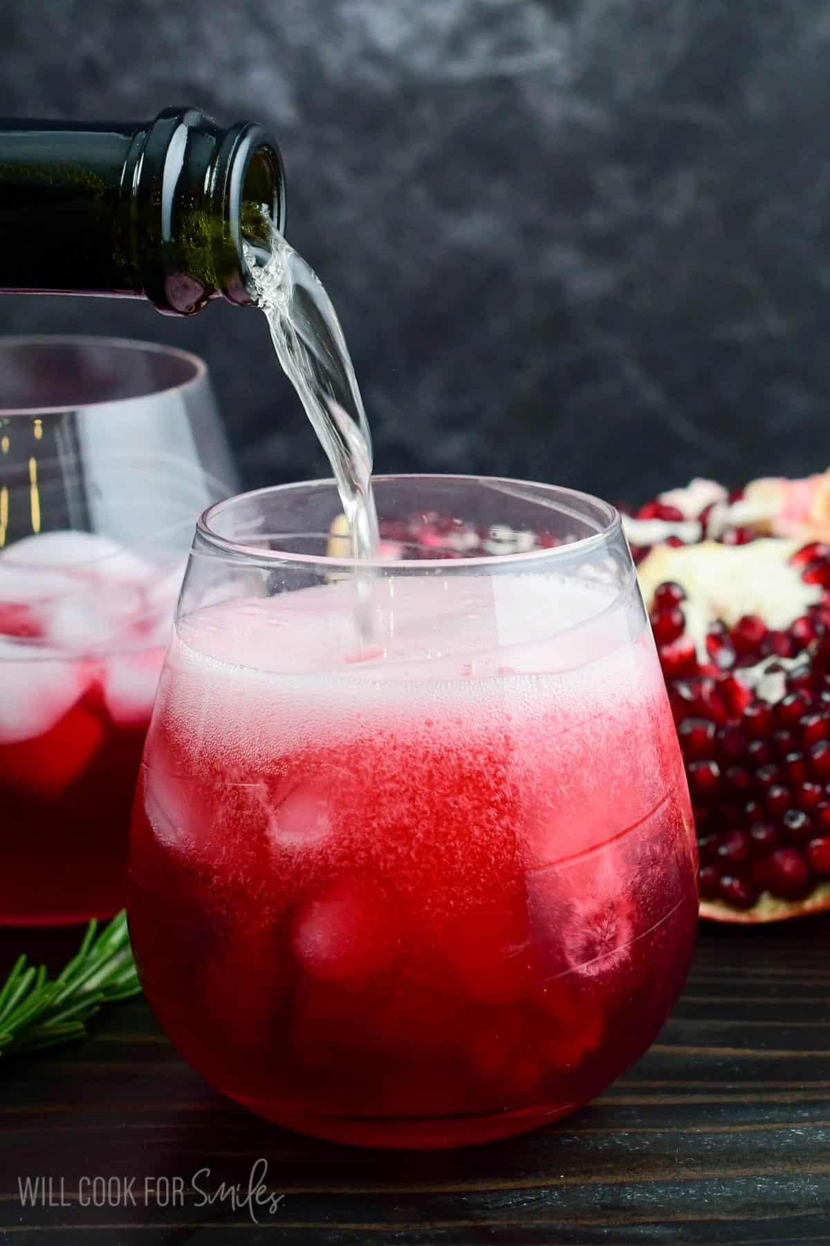 topping the gorgeous deep red gin cocktail with some bubbly prosecco.