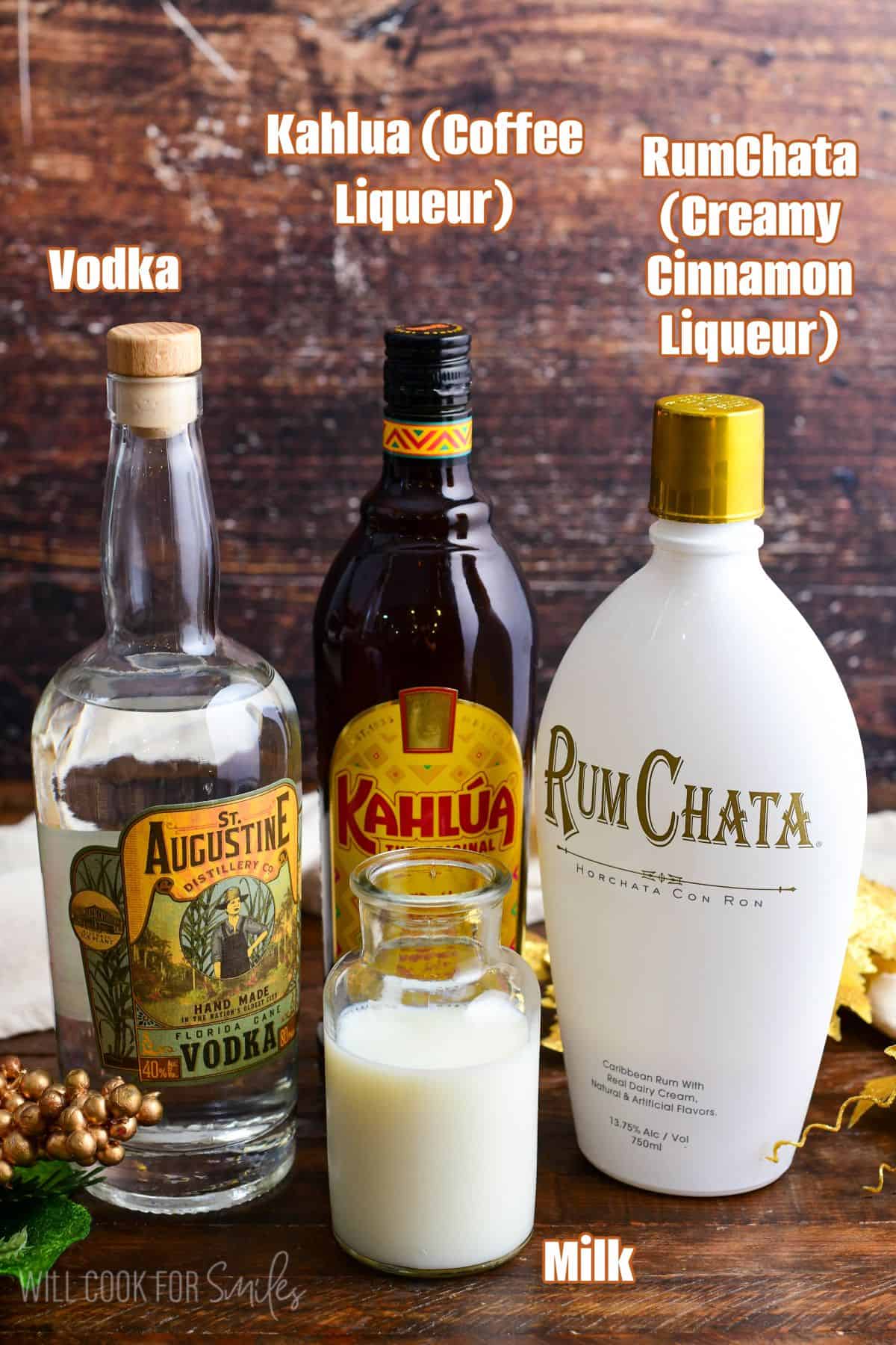 labeled ingredients for rumchata cocktail on a wood surface.
