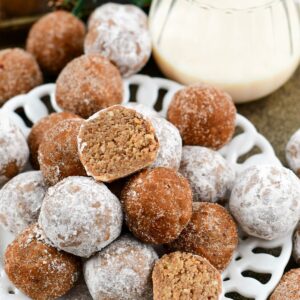 easy no bake Rumchata Rum balls stacked on a plate with one split in half.
