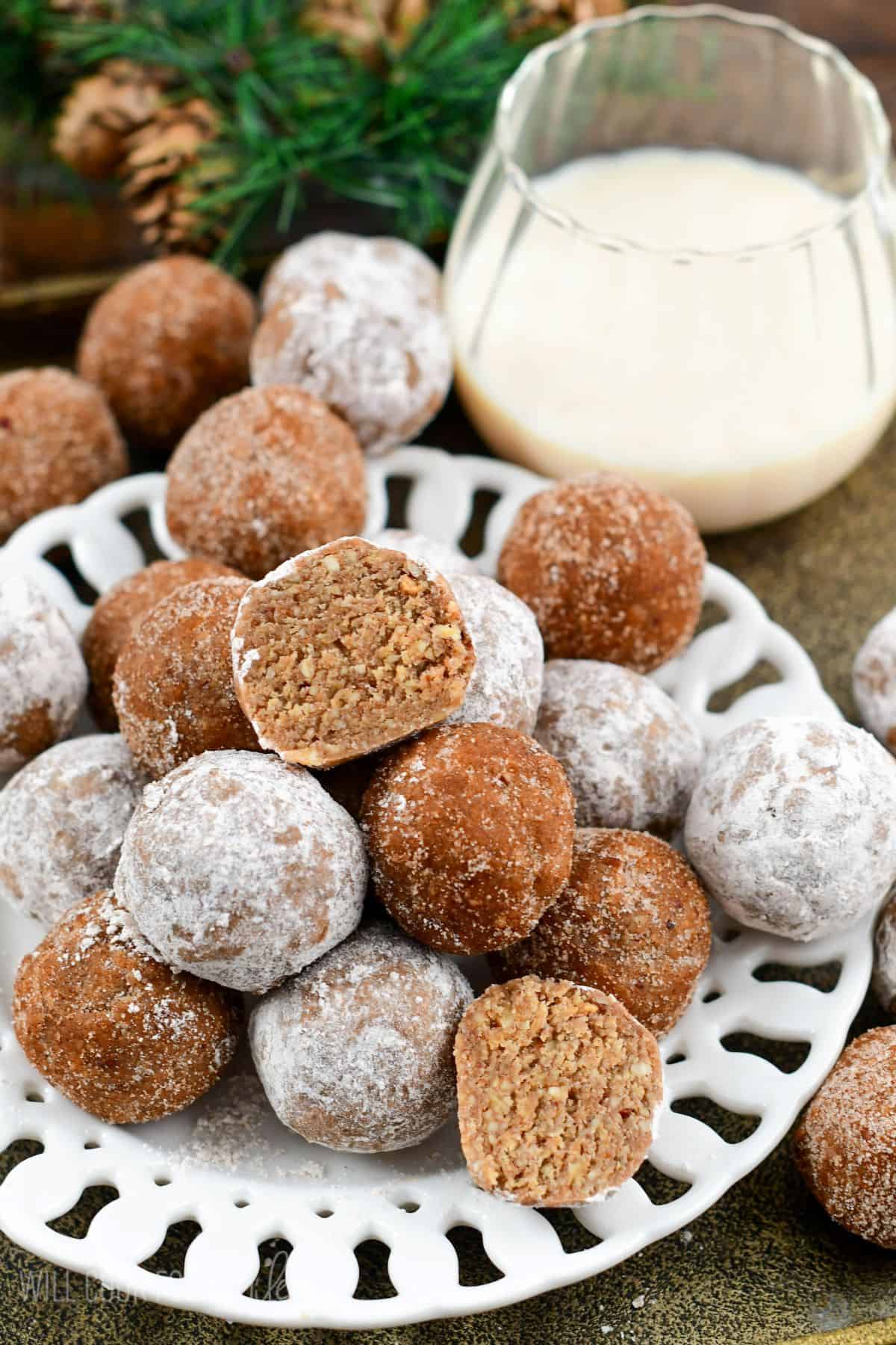 Rumchata Rum balls stacked on a plate with one split in half.