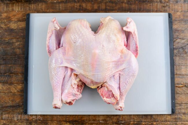 whole turkey on the cutting board butterflied.