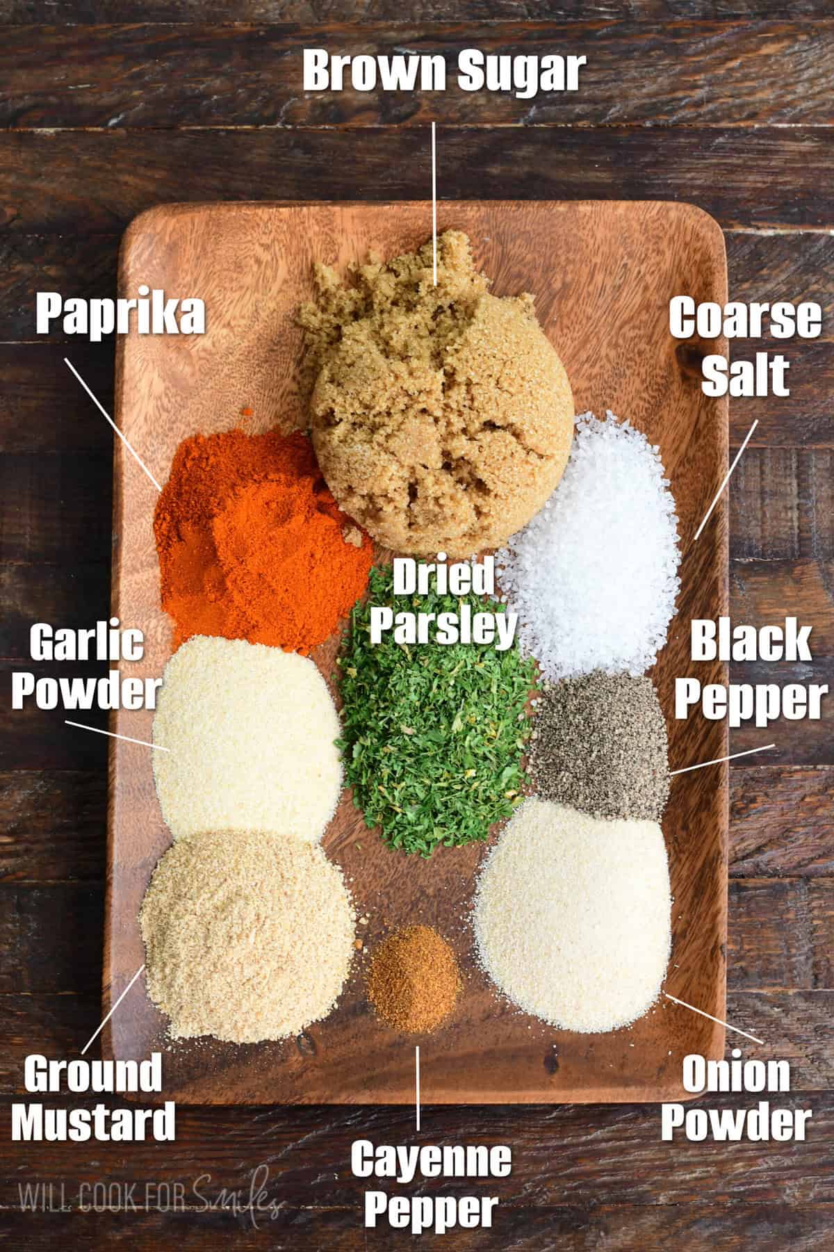 labeled ingredients on a wooden plate to make homemade pork rub.
