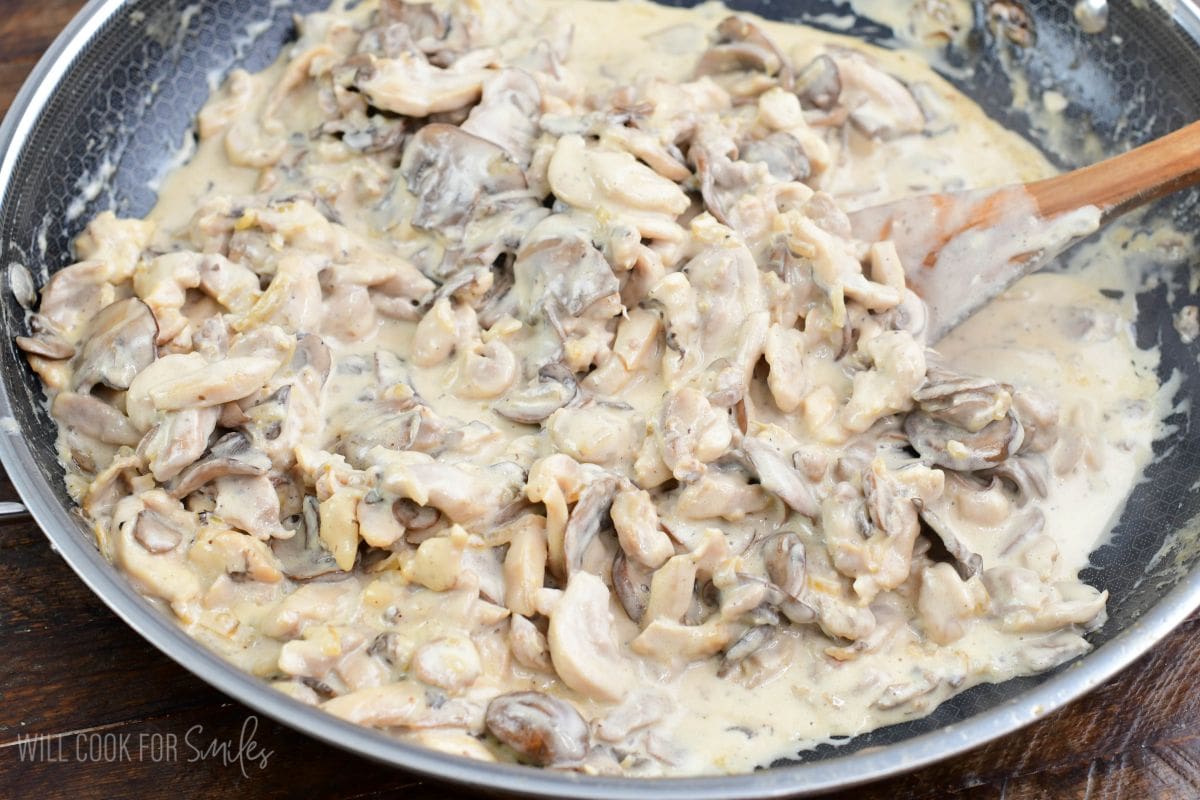 cooked creamy chicken stroganoff with mushrooms in a cooking pan.