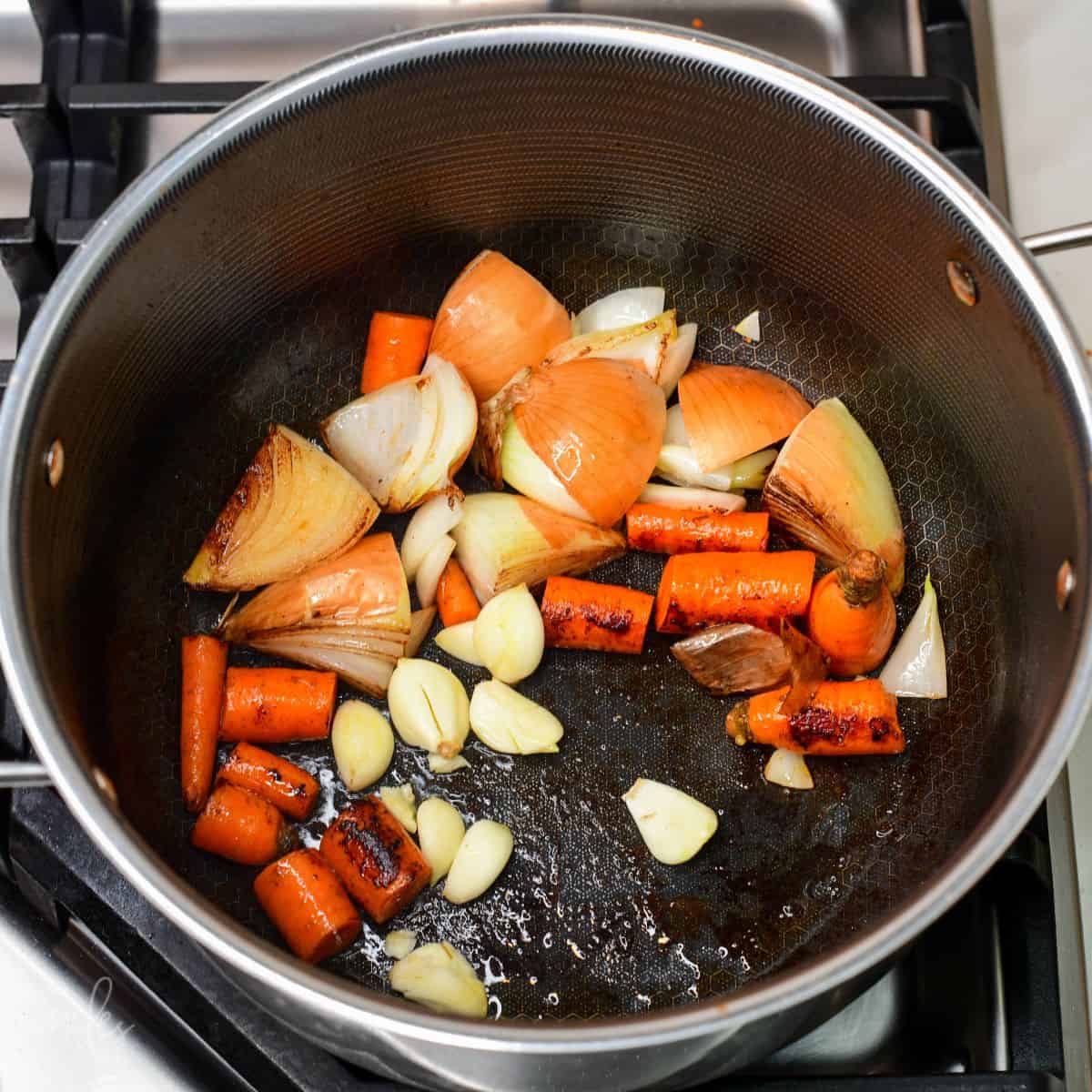searing quartered onions and carrots, and garlic for the beef broth.