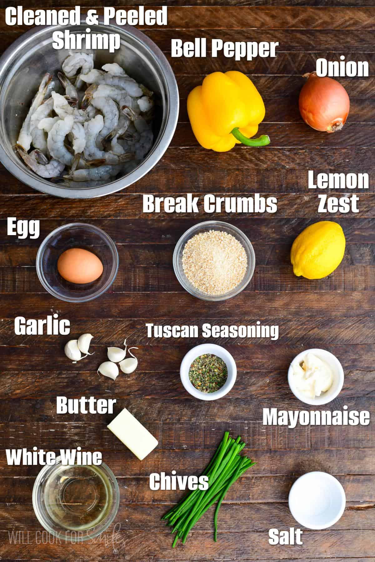 labeled ingredients to make shrimp scampi meatballs on a wooden board.
