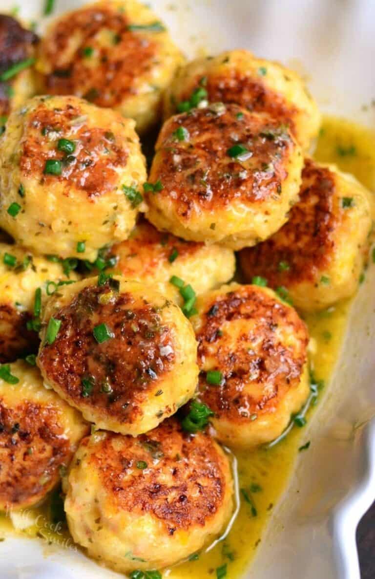 several juicy shrimp meatballs and flavorful scampi sauce in a serving bowl.